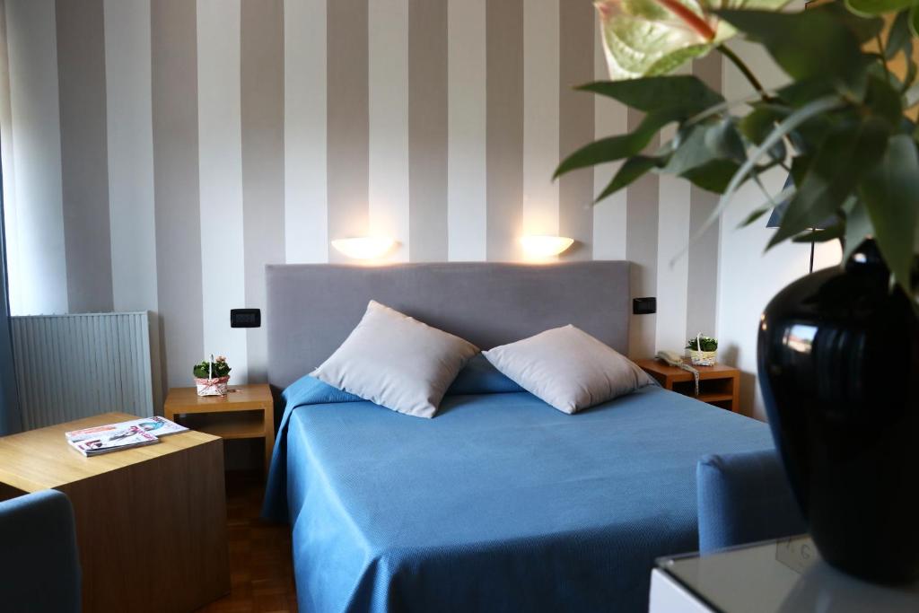 Postel nebo postele na pokoji v ubytování Hotel Clarici