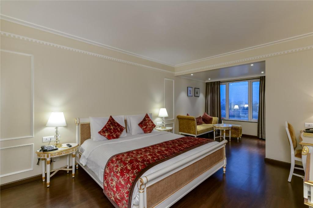 a hotel room with a large bed and a large window at Lemon Tree Premier “The Atrium” Ahmedabad in Ahmedabad