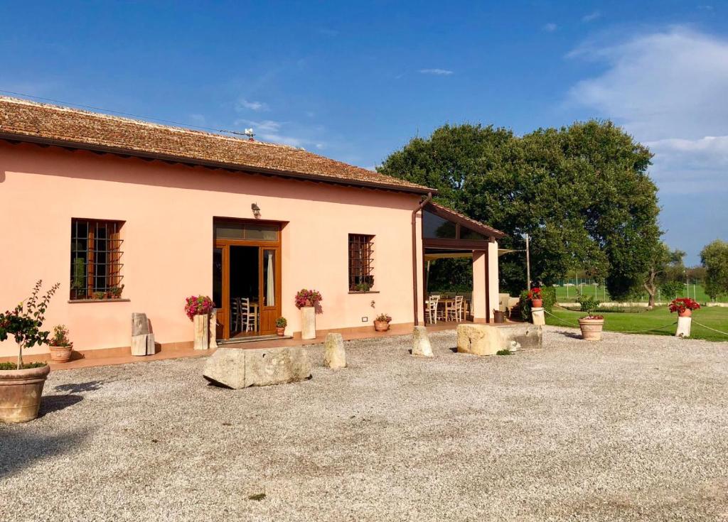a building with rocks in front of it at Agriturismo Ristorante Monte Argentario in Monte Argentario