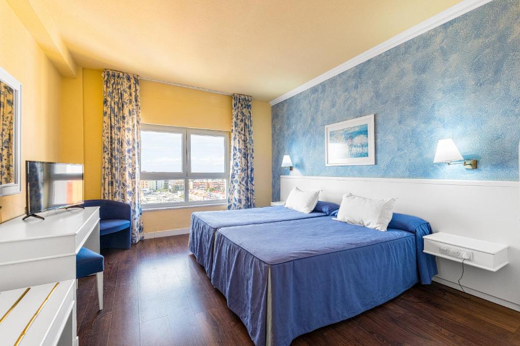 Ένα ή περισσότερα κρεβάτια σε δωμάτιο στο Hotel Guadalquivir