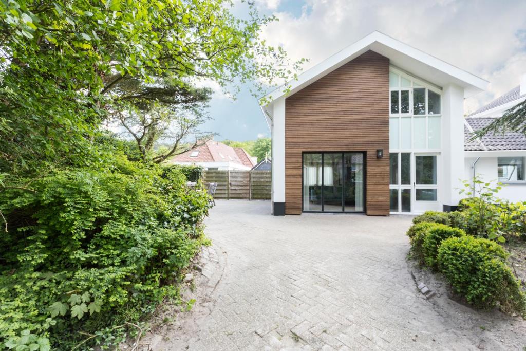 a house with a driveway in front of it at Villa Zeezout I Kloeg Collection in Zoutelande