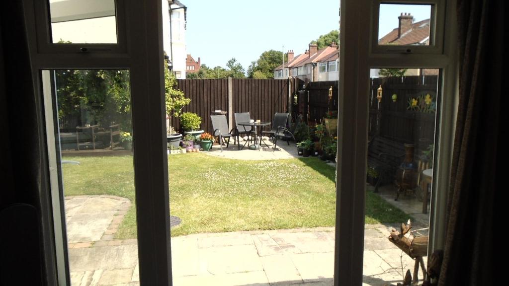 a window view of a yard with a patio at TEA in Liverpool - Private - Quiet - Ground Floor - En-suite - Walk-in-shower in Liverpool