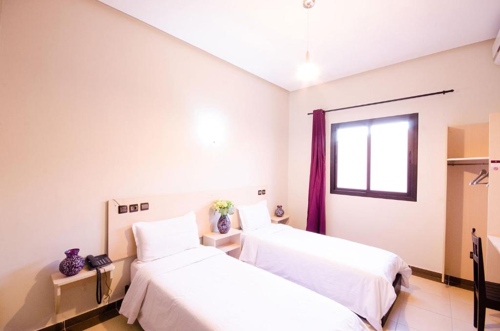 Postel nebo postele na pokoji v ubytování INOU Hotel