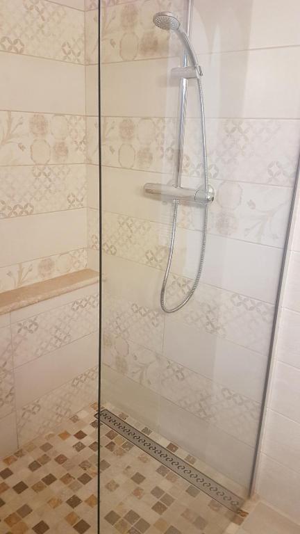 a shower with a glass door in a bathroom at Villa Manoe in Draguignan