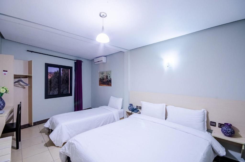 Postel nebo postele na pokoji v ubytování INOU Hotel