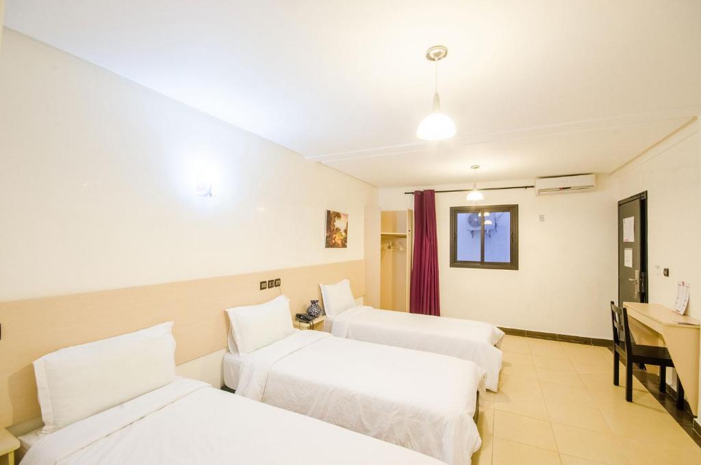 Postel nebo postele na pokoji v ubytování INOU Hotel