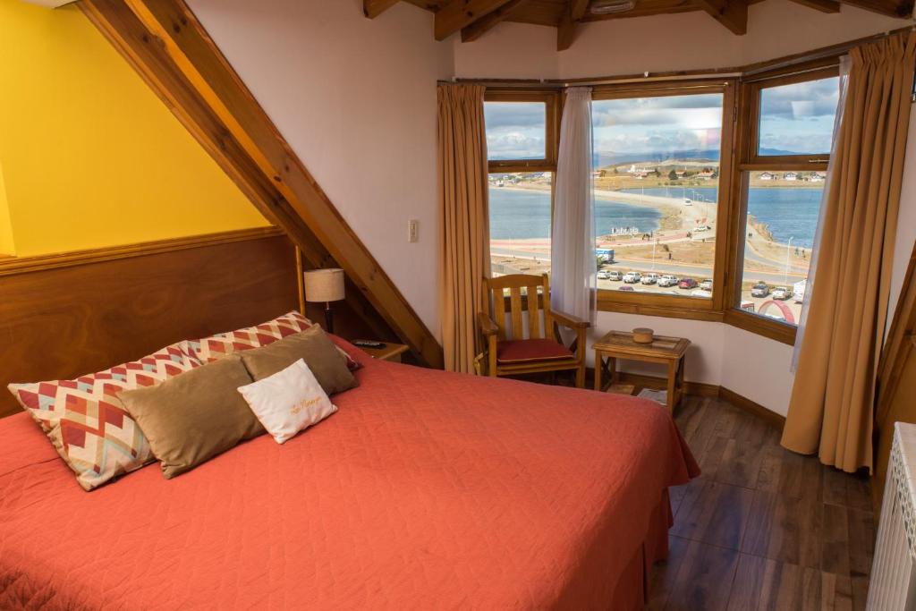 a bedroom with a bed with a view of the ocean at Los Naranjos in Ushuaia