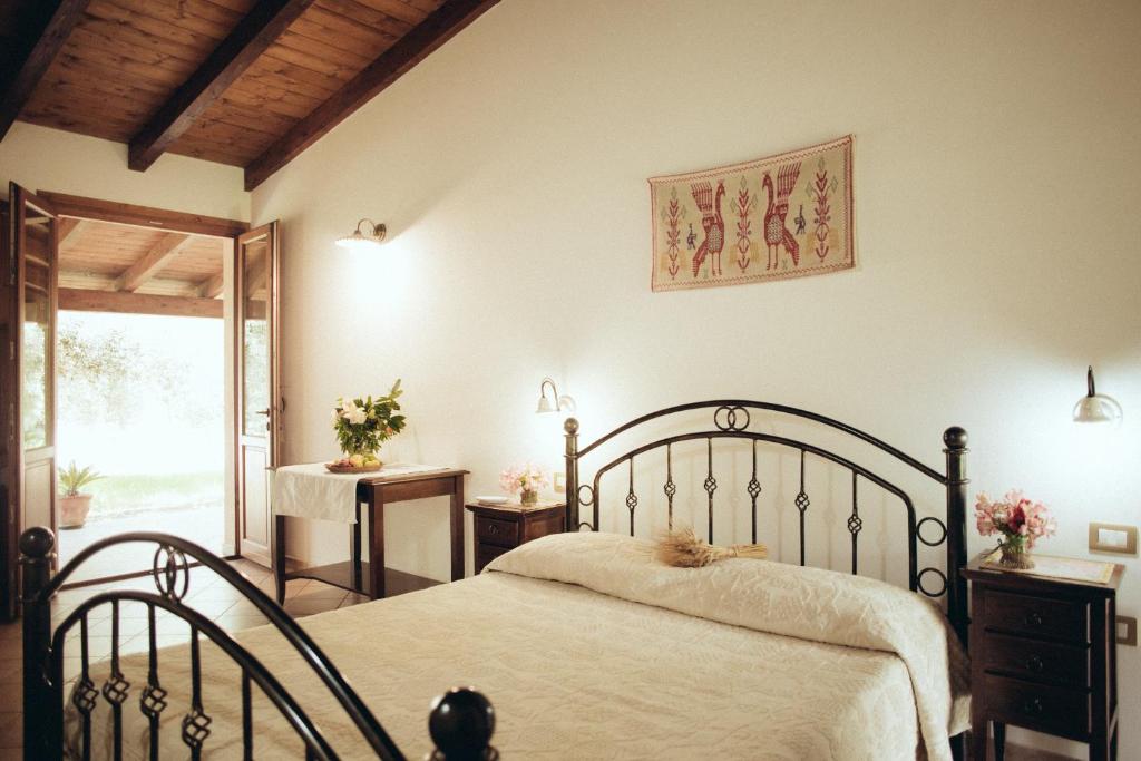 a bedroom with a bed and a sliding glass door at Su Leunaxiu in Solèminis