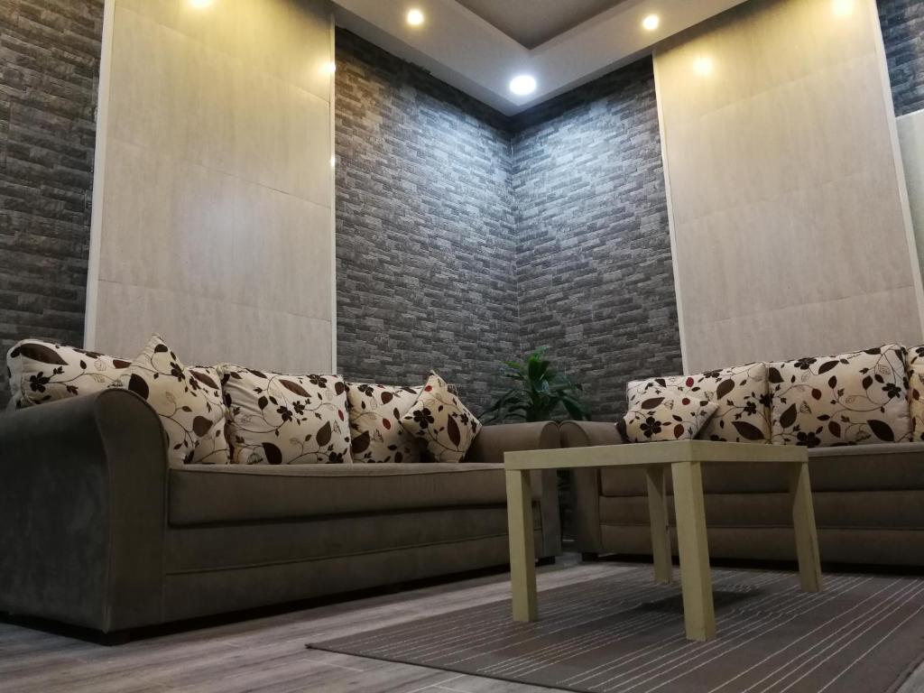 a living room with a couch and a table at B2-homes in Yanbu