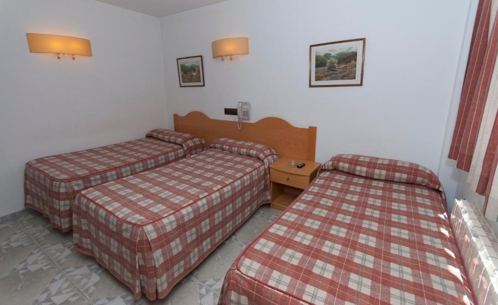 a hotel room with two beds in a room at Hostal Goyma II in San Fernando de Henares