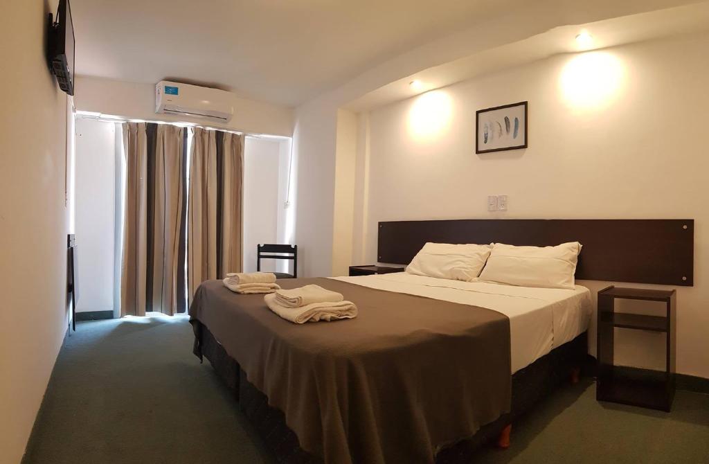 um quarto de hotel com uma cama com toalhas em Plaza em Termas de Rio Hondo
