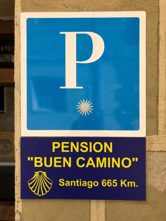 a sign on a building that says pension bitten camino at Pensión Buen Camino in Estella