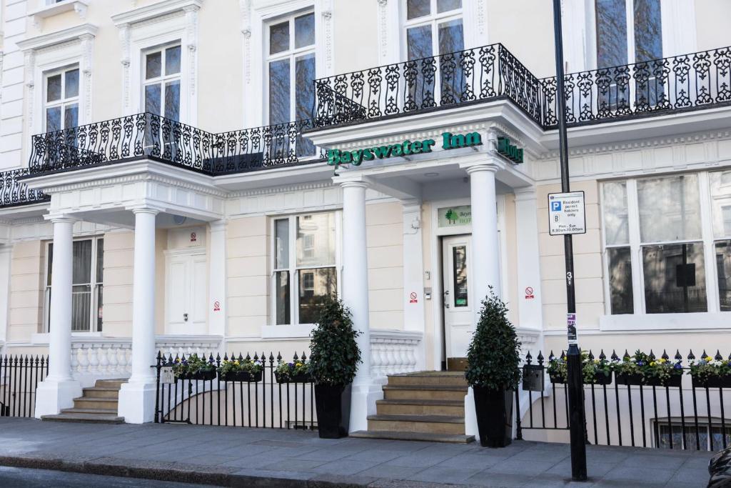 a white building with a sign on the front of it at Park Avenue Bayswater Inn Hyde Park in London