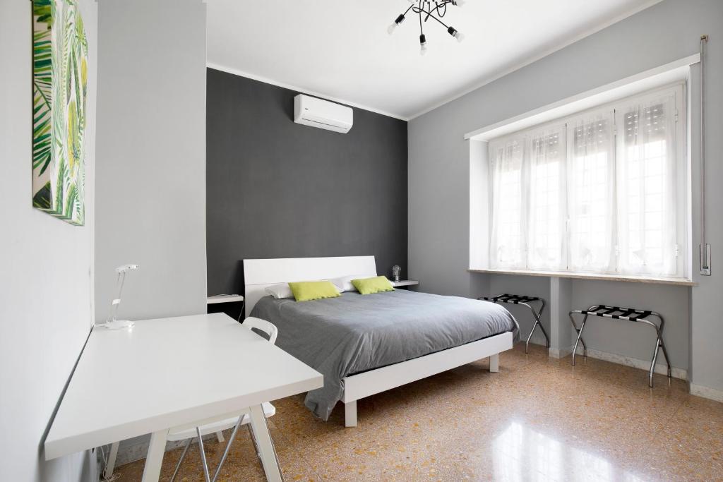 a bedroom with a bed and a window at Enjoy Porta Furba in Rome