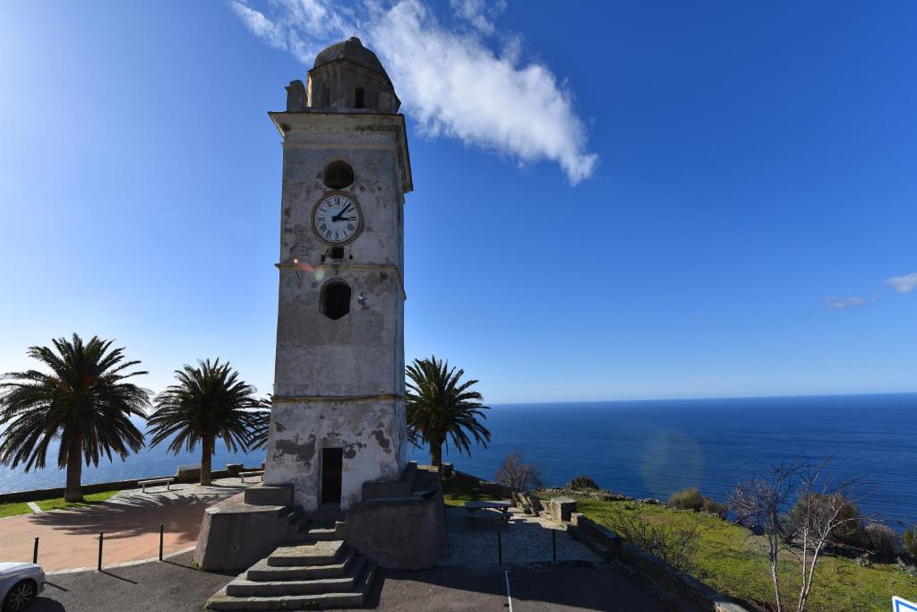 a clock tower with the ocean in the background at I Fioretti in Canari