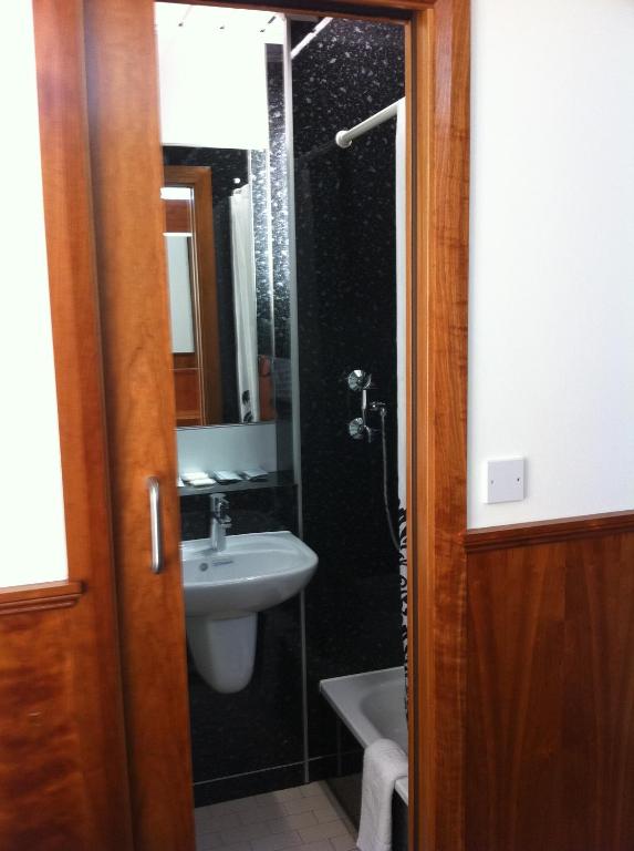 a bathroom with a shower and a sink at London Visitors Hotel in London
