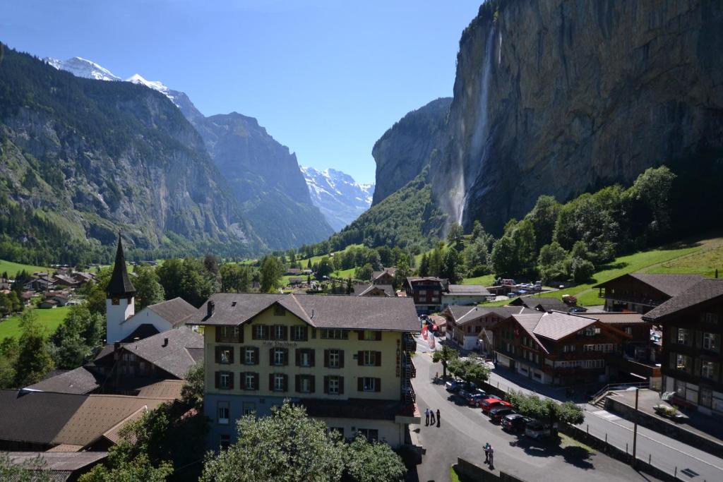 a town in a valley with mountains in the background at Hotel Staubbach in Lauterbrunnen