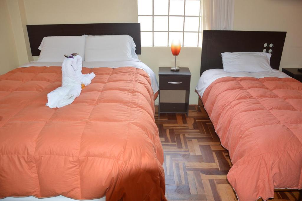 Postel nebo postele na pokoji v ubytování Hostal Wasichay