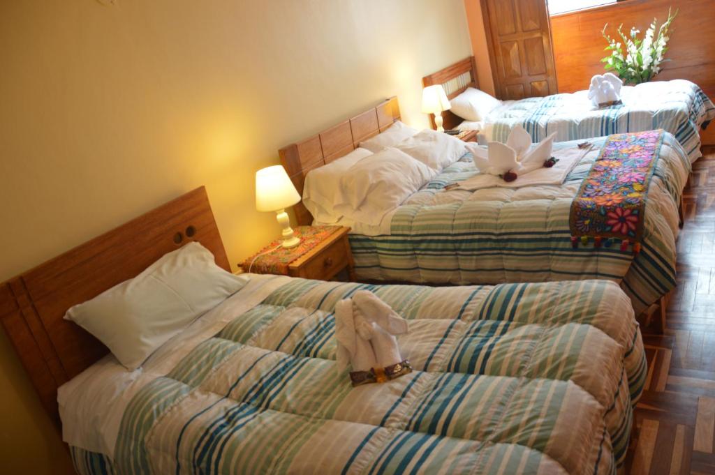 Postel nebo postele na pokoji v ubytování Hostal Wasichay