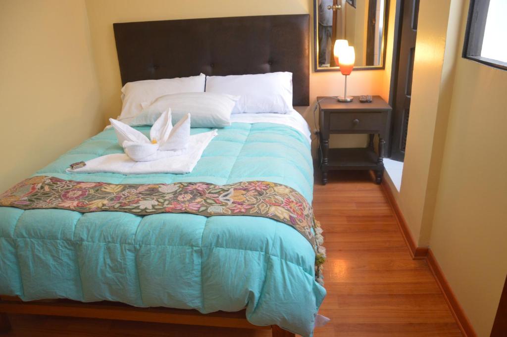 Postel nebo postele na pokoji v ubytování Hostal Wasichay