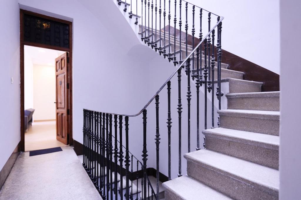 a staircase in a house with wrought iron railings at Apartamentos Dormavalencia in Valencia
