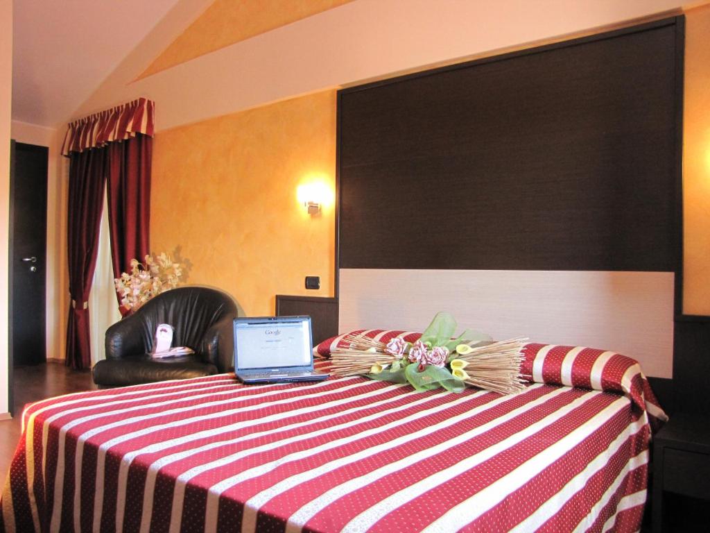 Postel nebo postele na pokoji v ubytování Hotel Iacone