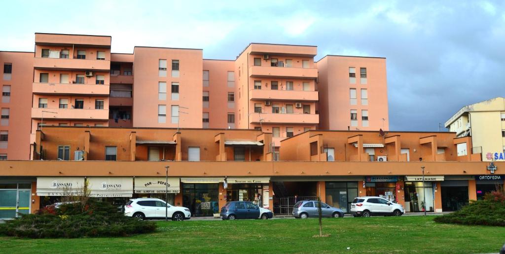 a large building with cars parked in a parking lot at Casa da Carlo in Pisa