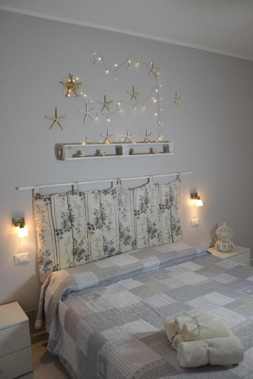 a bedroom with a large bed with stars on the wall at Blu Marlin in SantʼAntìoco