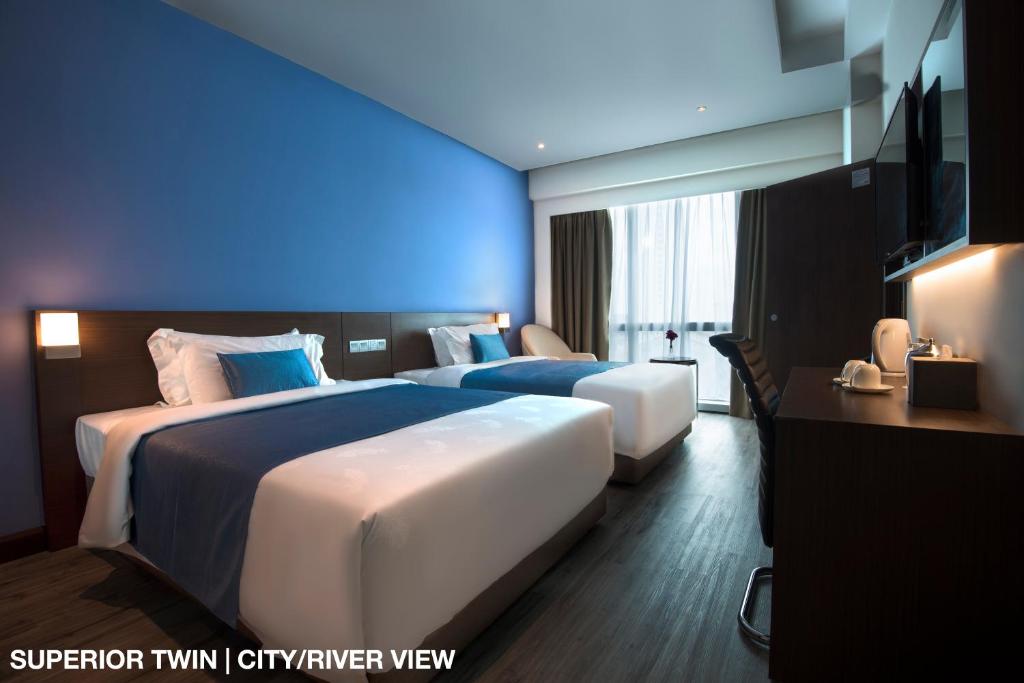 Postel nebo postele na pokoji v ubytování Astana Wing - Riverside Majestic Hotel