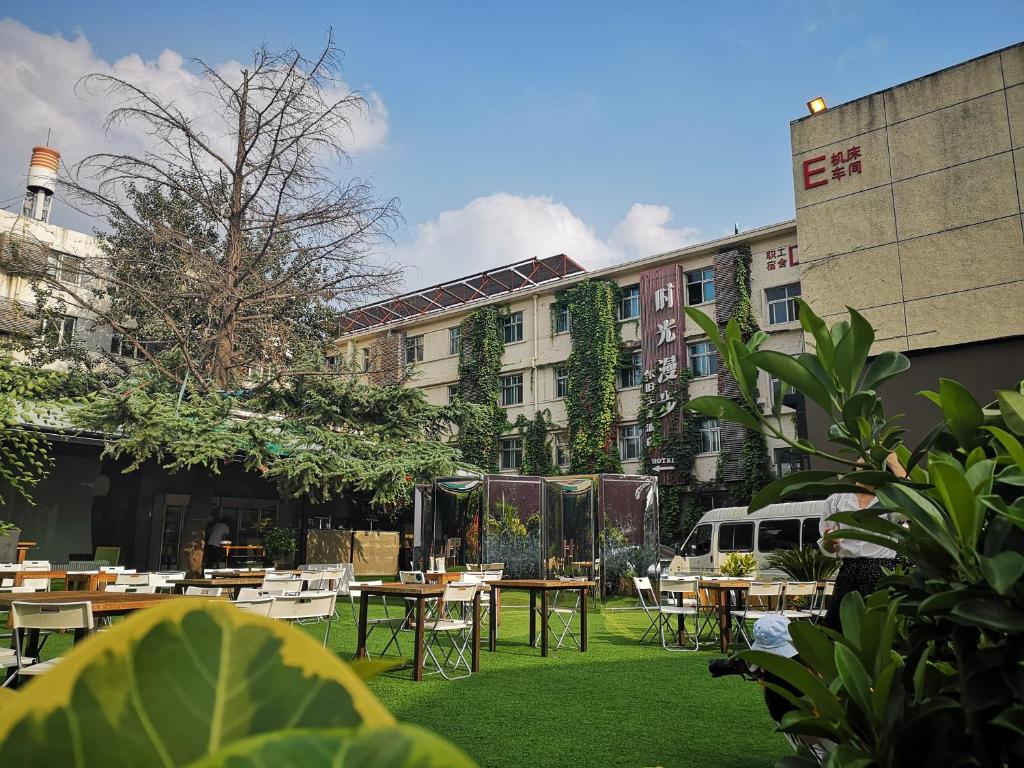 a courtyard with tables and chairs in front of a building at Nostalgia Hotel Beijing- Yonghe Lama Temple in Beijing