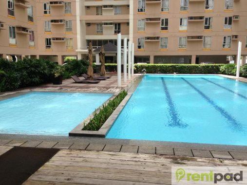 a large swimming pool in front of a building at Avida San Lazaro 1 BEDROOM with balcony near SM San Lazaro in Manila