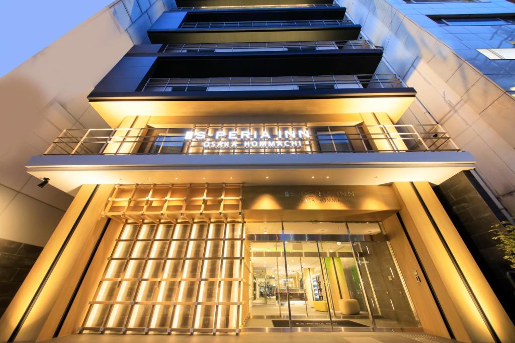 an external view of a building with lights at S-peria Inn Osaka Hommachi in Osaka