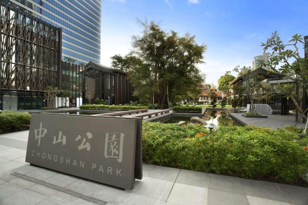 a park with a sign in front of a building at Days Hotel by Wyndham Singapore at Zhongshan Park in Singapore