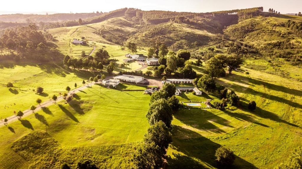 an aerial view of a house on a green field at St Ives Lodge in Lidgetton