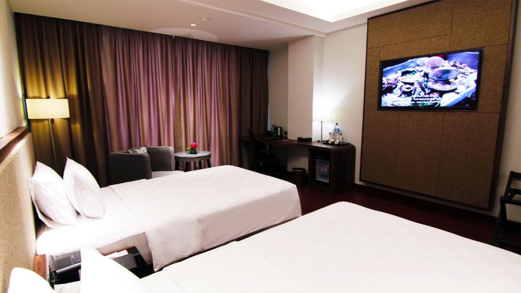 Postel nebo postele na pokoji v ubytování The Arista Hotel Palembang