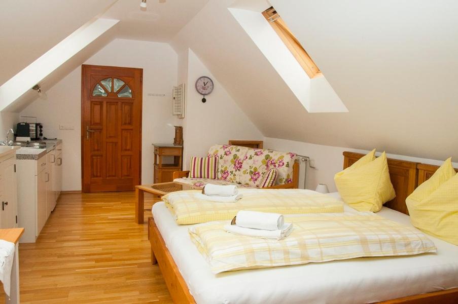 1 dormitorio con 2 camas y cocina en Biohof - Familie Neuberger, en Pöttelsdorf