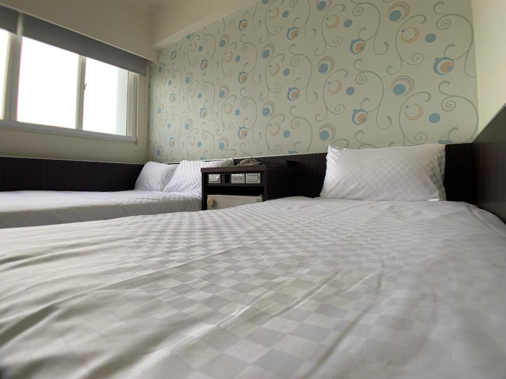 Postel nebo postele na pokoji v ubytování Penghu An-I Hotel