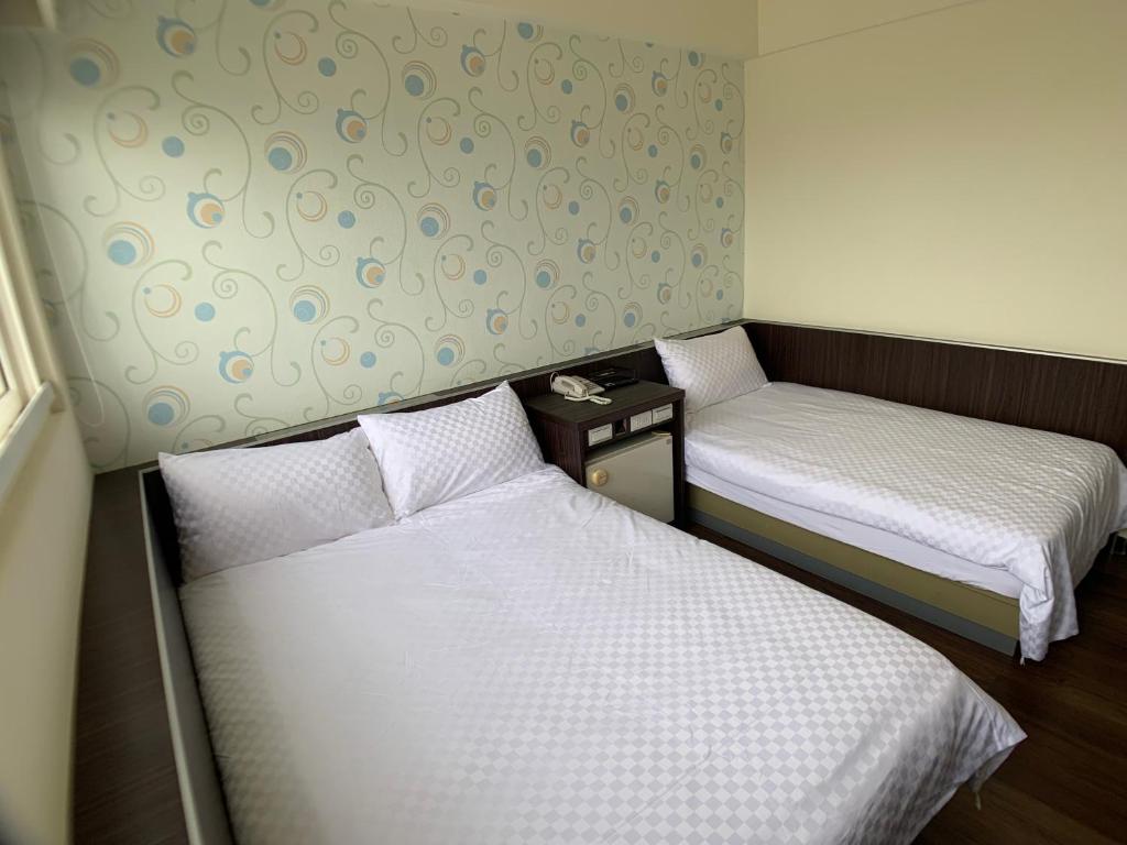 Postel nebo postele na pokoji v ubytování Penghu An-I Hotel