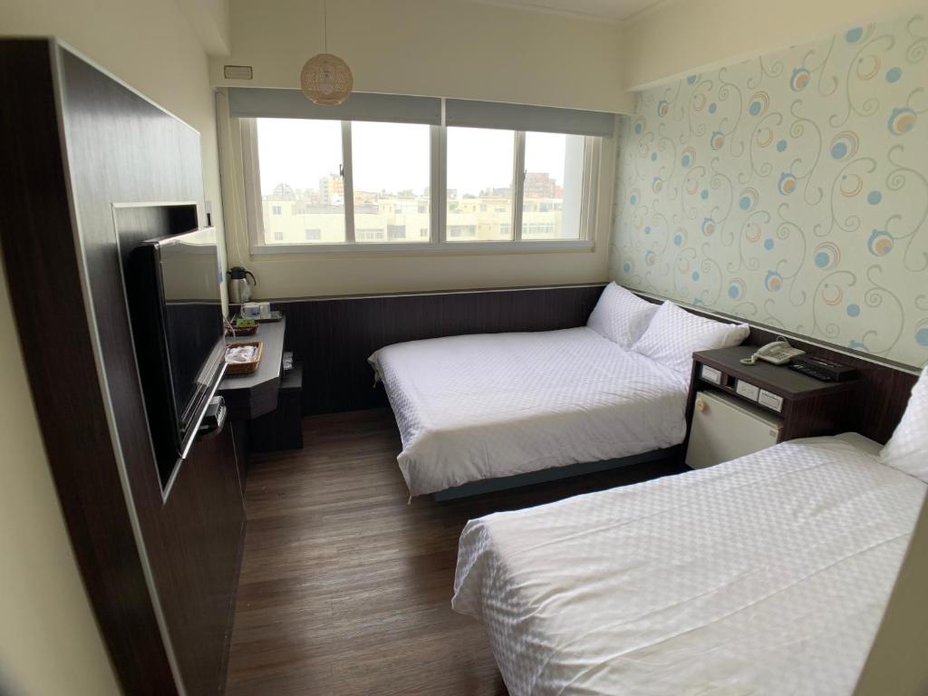 Postel nebo postele na pokoji v ubytování Penghu An-I Hotel