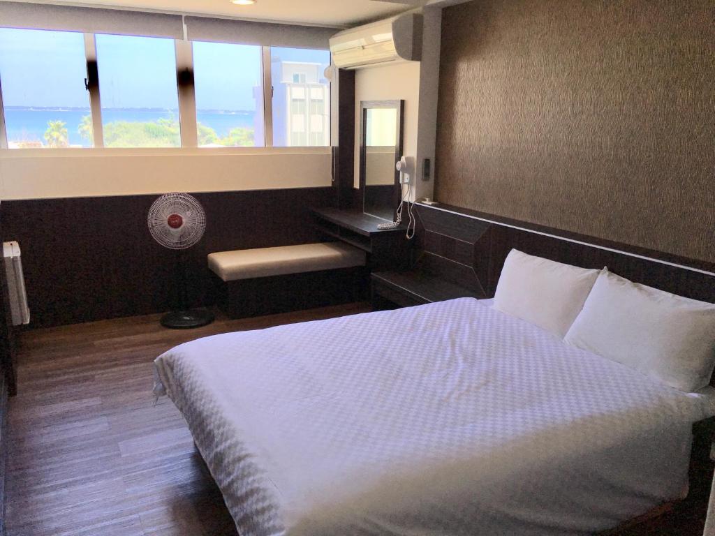 Postel nebo postele na pokoji v ubytování Penghu An-I Hotel