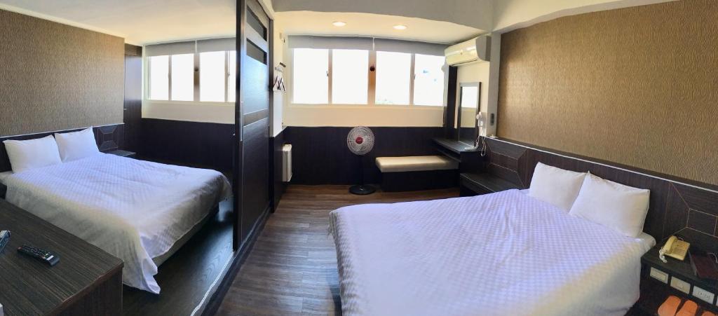 Postel nebo postele na pokoji v ubytování Penghu An-I Hotel