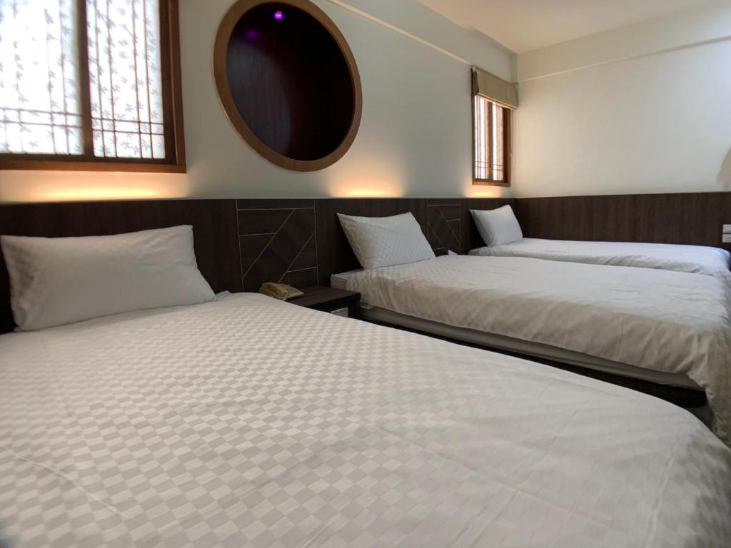 Postel nebo postele na pokoji v ubytování Penghu An-I Hotel