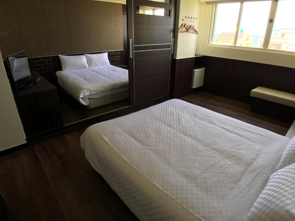 Postel nebo postele na pokoji v ubytování Penghu An-I Hotel