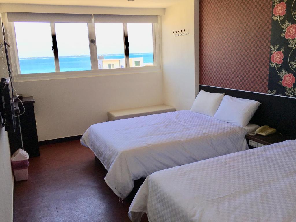 Postel nebo postele na pokoji v ubytování Penghu An-I Hotel