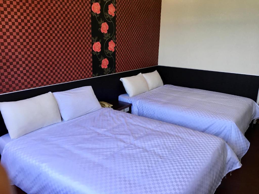 Postel nebo postele na pokoji v ubytování Penghu An-I Hotel