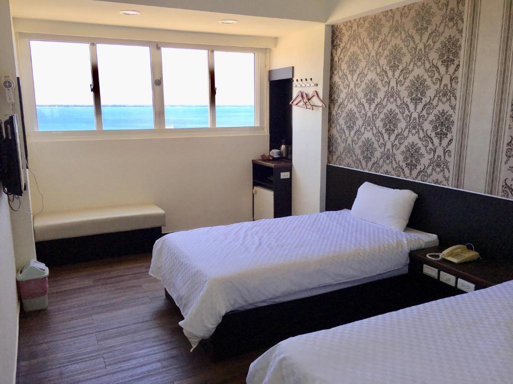Postel nebo postele na pokoji v ubytování Penghu An-I Hotel