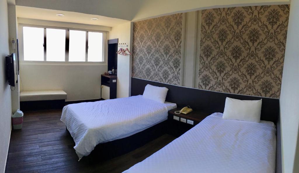 Postel nebo postele na pokoji v ubytování Penghu An-I Hotel