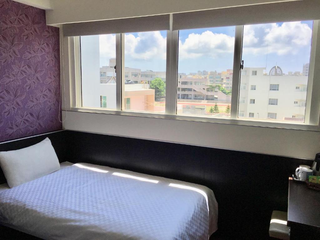 Postel nebo postele na pokoji v ubytování Penghu An-I Hotel