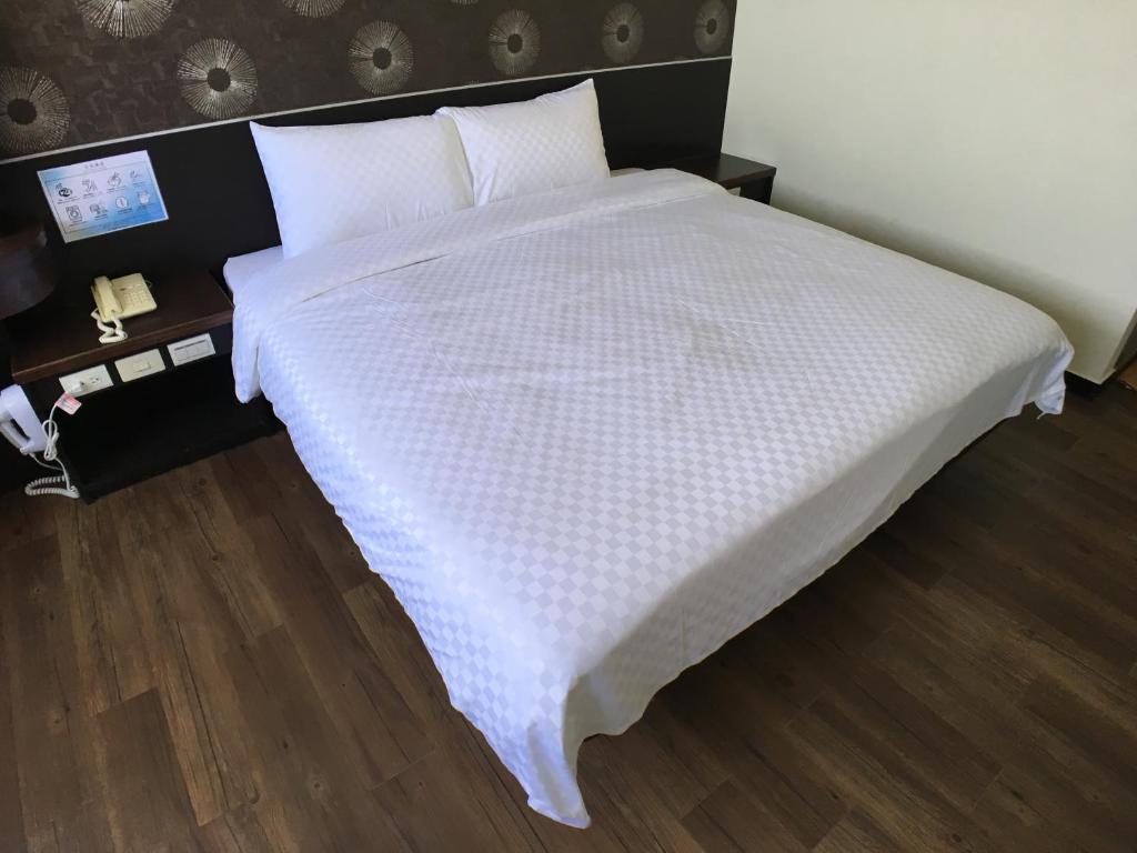 Postel nebo postele na pokoji v ubytování Penghu An-I Hotel