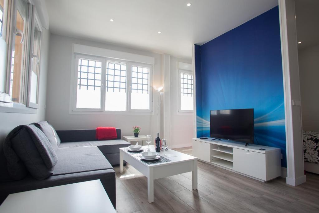 a living room with a couch and a tv at WindRose 8 in Madrid